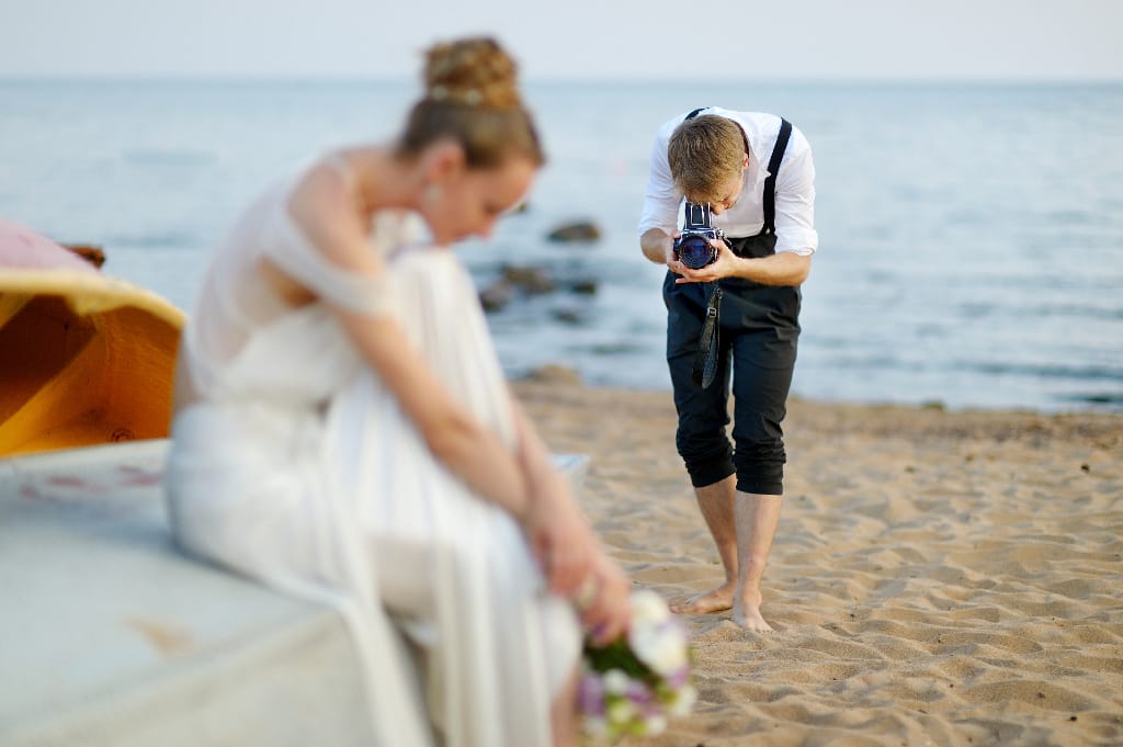 Groom,Taking,A,Photo,Of,His,Bride,With,A,Vintage